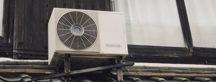 An HVAC unit on a roof that could use an upgrade to save money on energy bills.
