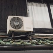 An HVAC unit on a roof that could use an upgrade to save money on energy bills.